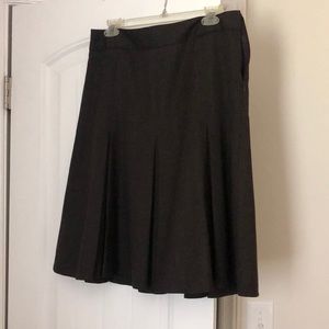 Pleated dark brown skirt.